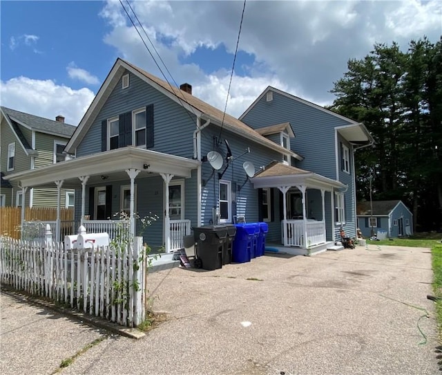 25 Eddy St, West Warwick, RI 02893 - view of front of house with a porch and a chimney