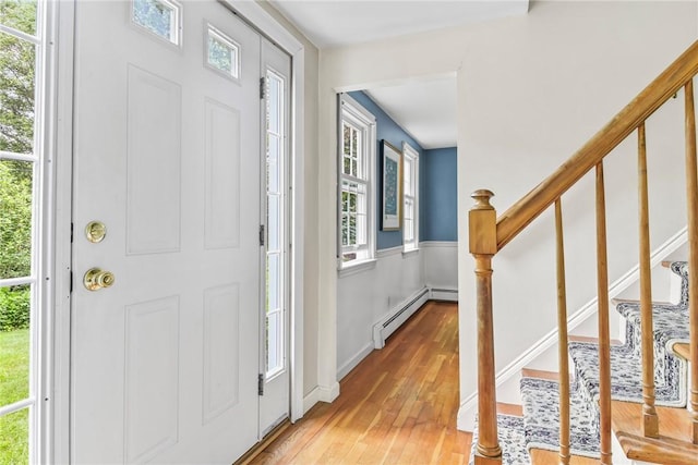 373 Fletcher Rd, North Kingstown, RI 02852 - foyer entrance with a baseboard radiator, light wood finished floors, and stairs
