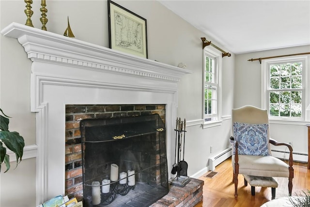 373 Fletcher Rd, North Kingstown, RI 02852 - living area featuring a fireplace, a baseboard radiator, and wood finished floors