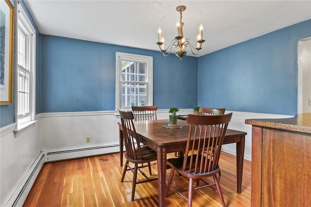 373 Fletcher Rd, North Kingstown, RI 02852 - dining room featuring wood-type flooring, a chandelier, baseboard heating, healthy amount of natural light, and a wainscoted wall