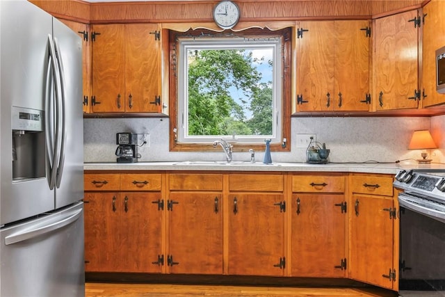 373 Fletcher Rd, North Kingstown, RI 02852 - kitchen with appliances with stainless steel finishes, light countertops, tasteful backsplash, and brown cabinets