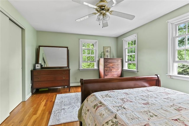 373 Fletcher Rd, North Kingstown, RI 02852 - bedroom featuring wood finished floors, baseboard heating, ceiling fan, and a closet