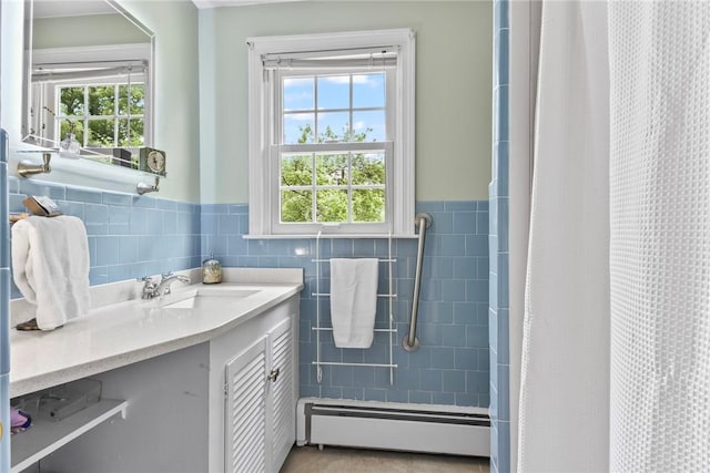 373 Fletcher Rd, North Kingstown, RI 02852 - bathroom with a baseboard heating unit, tile walls, vanity, wainscoting, and a shower with shower curtain