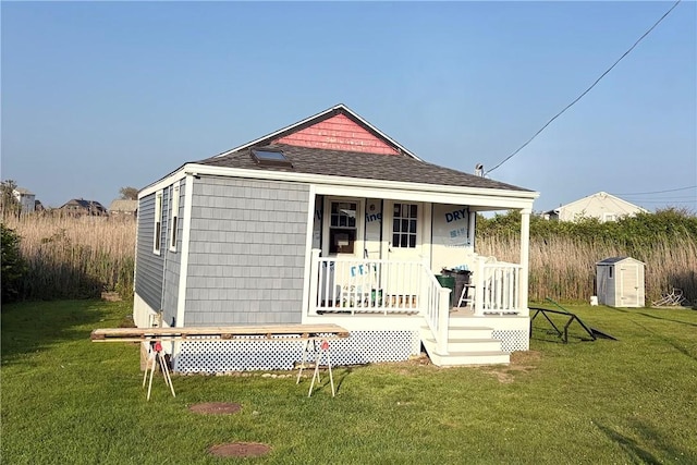 854 Matunuck Beach Rd, South Kingstown, RI 02879 - back of property with covered porch, a yard, a shingled roof, and an outbuilding