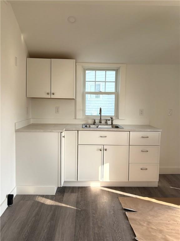 854 Matunuck Beach Rd, South Kingstown, RI 02879 - kitchen featuring dark wood-style floors, white cabinets, and light countertops