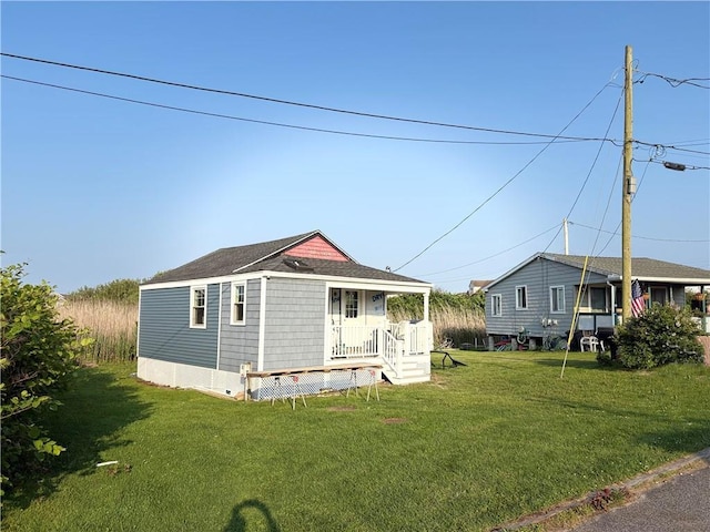854 Matunuck Beach Rd, South Kingstown, RI 02879 - view of front of home featuring a front lawn and roof with shingles