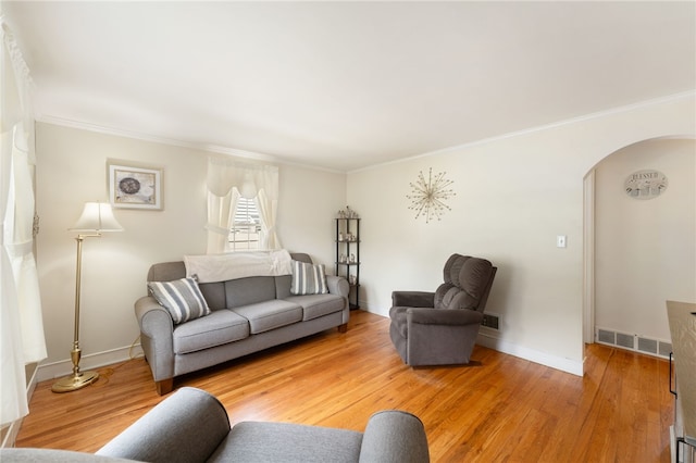 59 Massachusetts Ave, Warwick, RI 02888 - living area featuring arched walkways, light wood-style flooring, and ornamental molding