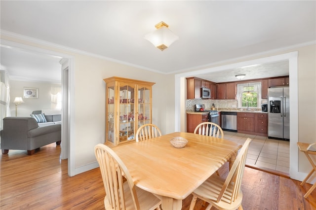 59 Massachusetts Ave, Warwick, RI 02888 - dining space with light wood finished floors and ornamental molding