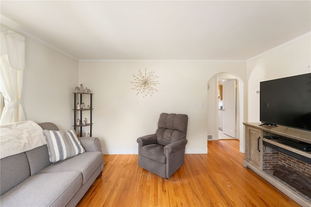 59 Massachusetts Ave, Warwick, RI 02888 - living room featuring arched walkways, crown molding, and light wood finished floors