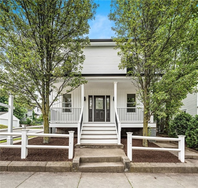 1314 Chalkstone Ave, Providence, RI 02908 - view of front facade with covered porch and a fenced front yard