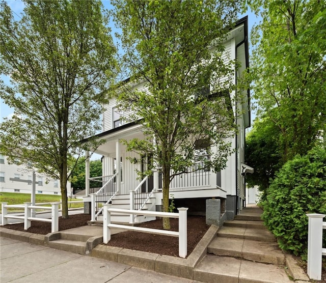 1314 Chalkstone Ave, Providence, RI 02908 - view of front facade featuring a porch, board and batten siding, and stairway