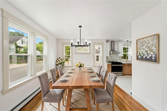 1314 Chalkstone Ave, Providence, RI 02908 - dining space with a chandelier, light wood-style floors, and baseboard heating