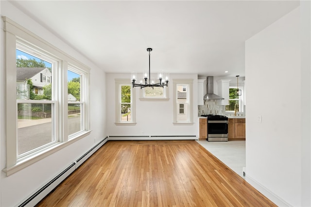 1314 Chalkstone Ave, Providence, RI 02908 - unfurnished dining area with a chandelier, a baseboard heating unit, light wood-type flooring, and a baseboard radiator
