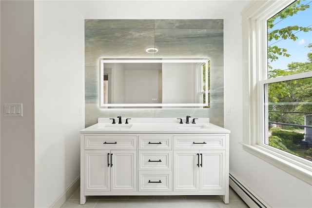 1314 Chalkstone Ave, Providence, RI 02908 - bathroom featuring a baseboard radiator, double vanity, and tile patterned flooring