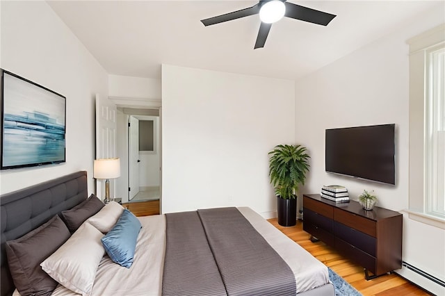 1314 Chalkstone Ave, Providence, RI 02908 - bedroom featuring a baseboard heating unit, light wood-style floors, and a ceiling fan
