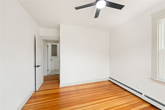 1314 Chalkstone Ave, Providence, RI 02908 - spare room featuring a baseboard heating unit, ceiling fan, and light wood finished floors