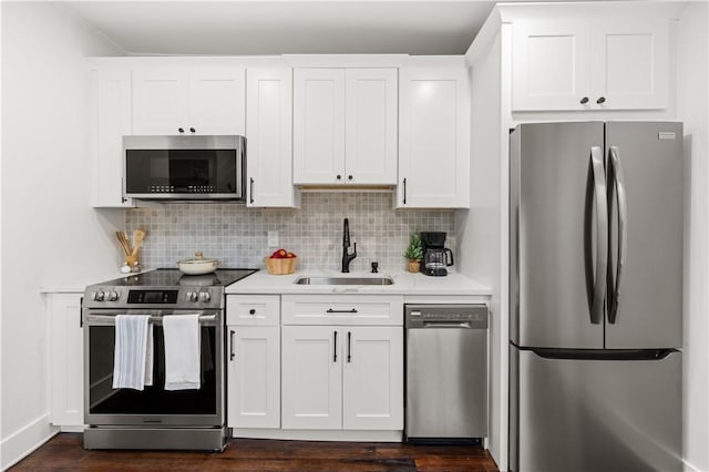 51 Poplar St Unit 1R, Newport, RI 02840 - kitchen with appliances with stainless steel finishes, light countertops, backsplash, and white cabinets