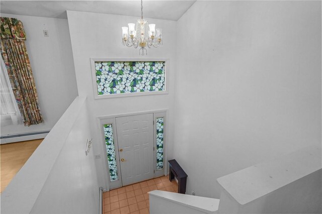2 Birch St, Johnston, RI 02919 - entryway with baseboard heating, a chandelier, and a towering ceiling