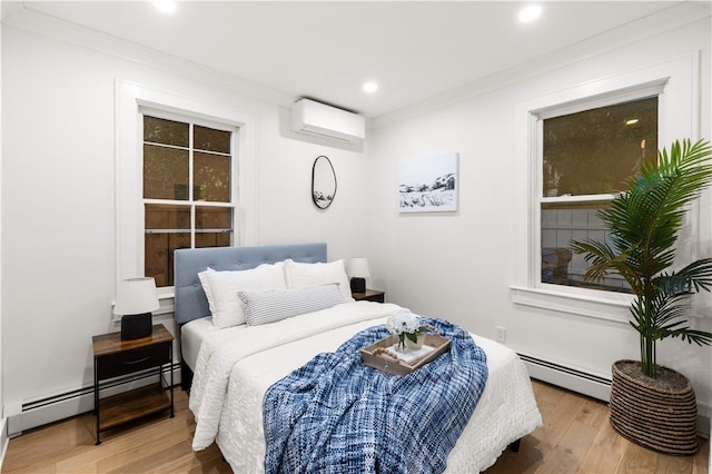 51 Poplar St Unit 1L, Newport, RI 02840 - bedroom with a wall mounted air conditioner, baseboard heating, wood finished floors, recessed lighting, and crown molding