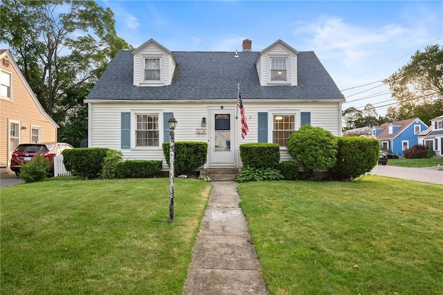 3 Arrow Ave, Warwick, RI 02886 - cape cod house featuring a front yard, roof with shingles, and a chimney