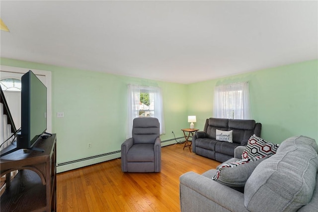 3 Arrow Ave, Warwick, RI 02886 - living room featuring a baseboard heating unit, plenty of natural light, and light wood-style flooring
