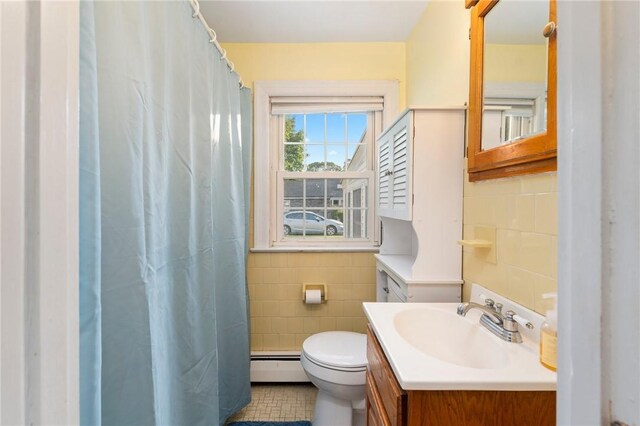 3 Arrow Ave, Warwick, RI 02886 - bathroom featuring tile walls, a baseboard heating unit, vanity, a shower with shower curtain, and tile patterned floors