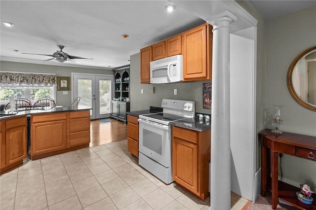 11 Daventry St, Glocester, RI 02814 - kitchen with white appliances, dark countertops, ceiling fan, light tile patterned flooring, and brown cabinetry