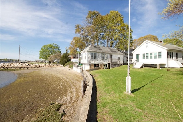 66 Beach St, Warren, RI 02885 - view of front of house featuring a front yard, a wooden deck, and stairs