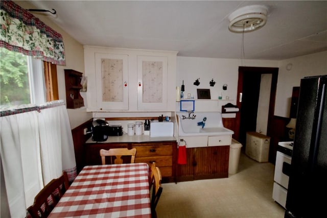 66 Beach St, Warren, RI 02885 - kitchen featuring freestanding refrigerator, white cabinets, stove, and light countertops