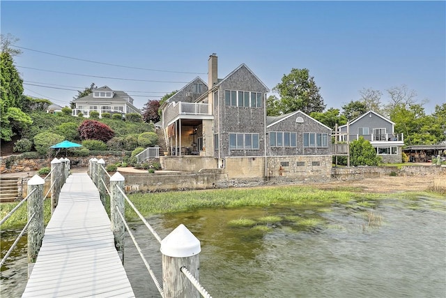 8 Alger Ave, Warwick, RI 02818 - rear view of house featuring a balcony, a water view, and a chimney