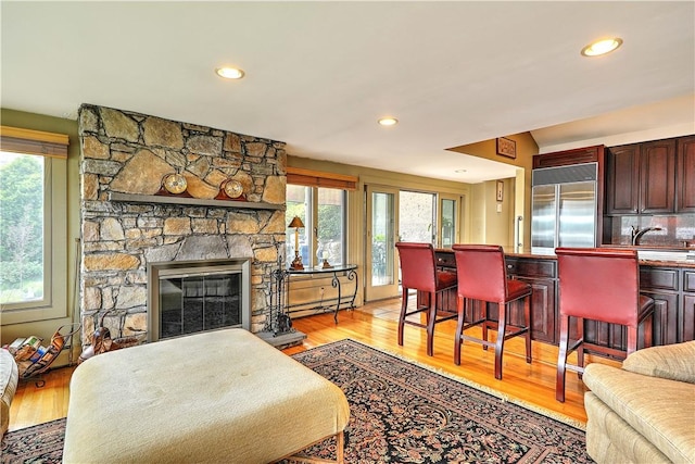 8 Alger Ave, Warwick, RI 02818 - living room featuring healthy amount of natural light, light wood finished floors, recessed lighting, and a stone fireplace