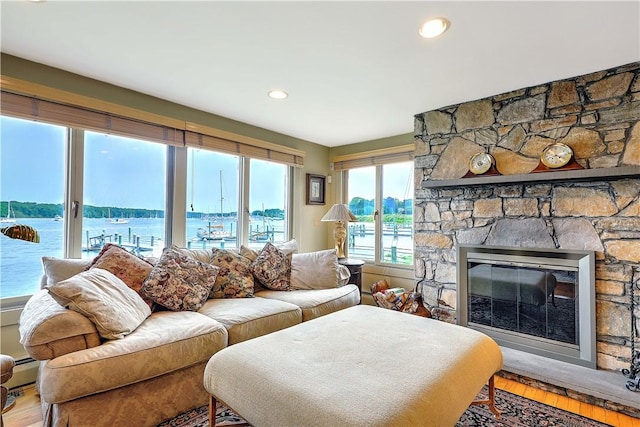 8 Alger Ave, Warwick, RI 02818 - living room with wood finished floors, a water view, a fireplace, and recessed lighting