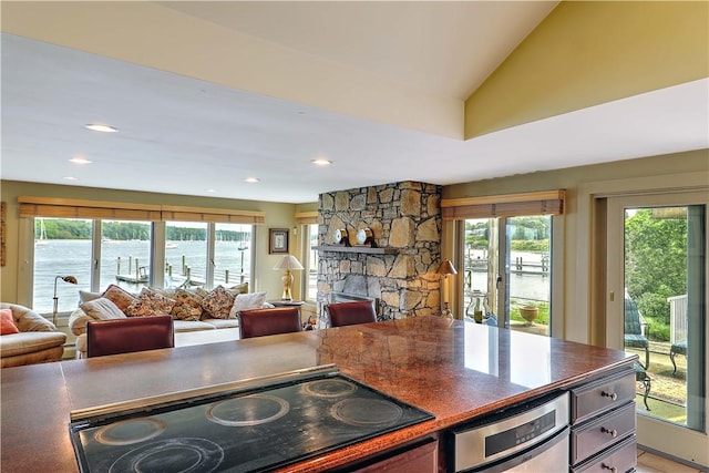 8 Alger Ave, Warwick, RI 02818 - kitchen with black electric cooktop, open floor plan, healthy amount of natural light, a fireplace, and recessed lighting