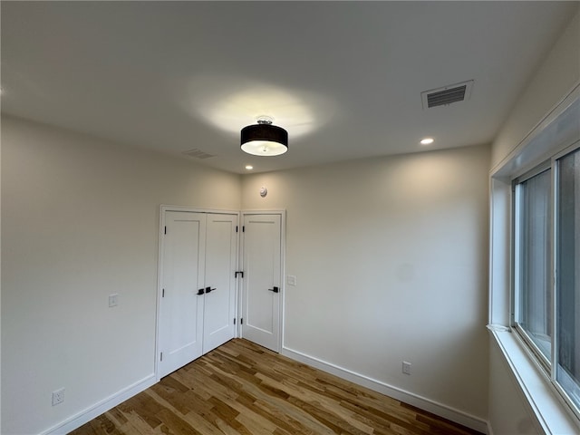 12 Daggett Ct Unit 2, Providence, RI 02906 - unfurnished bedroom featuring wood finished floors, recessed lighting, and a closet