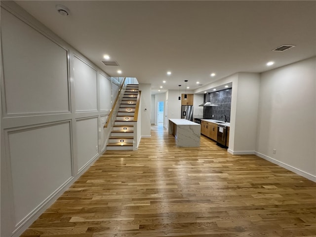 12 Daggett Ct Unit 2, Providence, RI 02906 - unfurnished living room with light wood-style floors, stairway, and recessed lighting