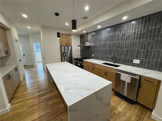 12 Daggett Ct Unit 2, Providence, RI 02906 - kitchen featuring appliances with stainless steel finishes, brown cabinets, a kitchen island, backsplash, and recessed lighting
