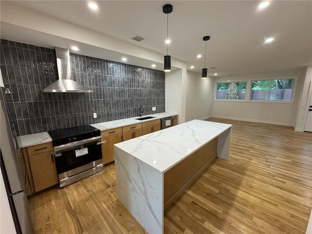 12 Daggett Ct Unit 2, Providence, RI 02906 - kitchen with appliances with stainless steel finishes, wall chimney exhaust hood, brown cabinets, light wood-style flooring, and recessed lighting