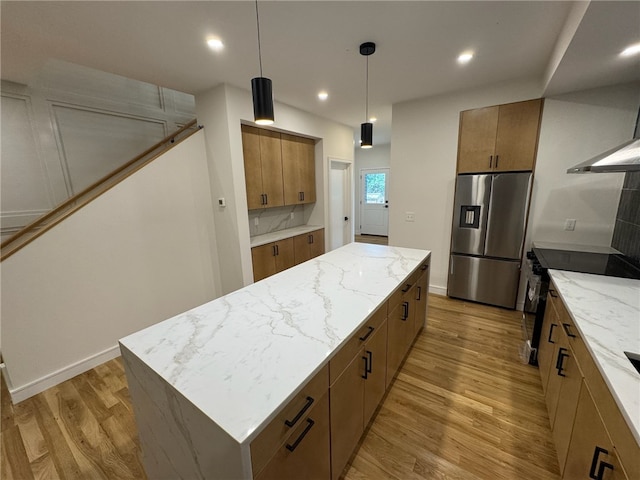 12 Daggett Ct Unit 2, Providence, RI 02906 - kitchen with stainless steel fridge with ice dispenser, a center island, light wood-style floors, brown cabinets, and light stone counters