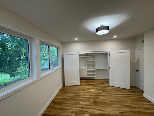 12 Daggett Ct Unit 2, Providence, RI 02906 - unfurnished bedroom with wood finished floors, recessed lighting, and a closet