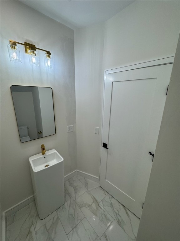 12 Daggett Ct Unit 2, Providence, RI 02906 - bathroom featuring baseboards and marble look tiles