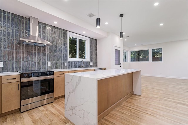 12 Daggett Ct Unit 2, Providence, RI 02906 - kitchen featuring stainless steel electric stove, wall chimney exhaust hood, decorative backsplash, light wood-type flooring, and recessed lighting