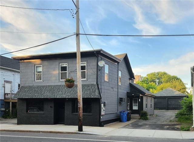 415 Broad St, Cumberland, RI 02864 - view of front of property featuring a shingled roof and brick siding
