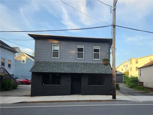 415 Broad St, Cumberland, RI 02864 - view of front of home with a shingled roof and brick siding