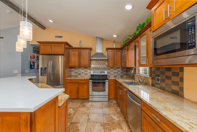 136 Youngs Ave, Coventry, RI 02816 - kitchen featuring appliances with stainless steel finishes, wall chimney exhaust hood, brown cabinetry, lofted ceiling, and decorative backsplash