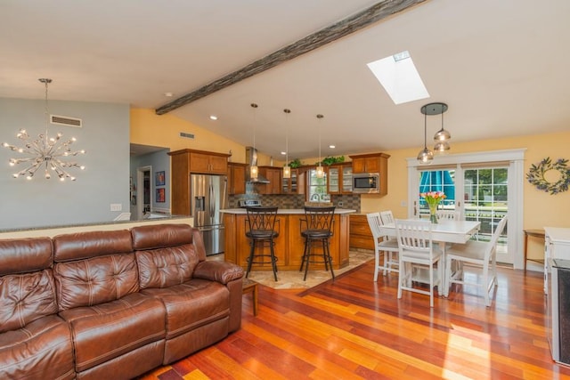 136 Youngs Ave, Coventry, RI 02816 - living area featuring a skylight, light wood-type flooring, and a chandelier