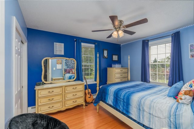 136 Youngs Ave, Coventry, RI 02816 - bedroom featuring wood finished floors, a ceiling fan, baseboard heating, and a closet