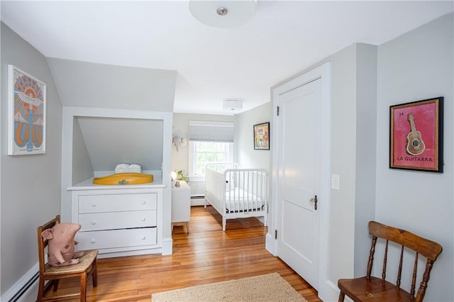 280 S Pierce Rd, East Greenwich, RI 02818 - bedroom with a baseboard heating unit and wood finished floors
