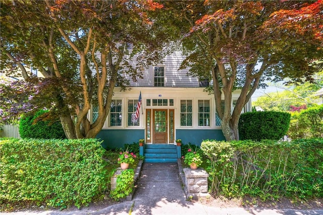 24 Old Beach Rd, Newport, RI 02840 - view of front of house featuring stucco siding and entry steps