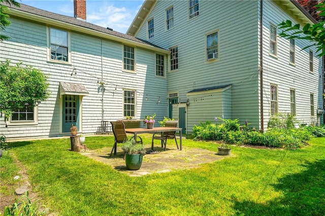 24 Old Beach Rd, Newport, RI 02840 - back of property with a chimney, a patio area, and a yard