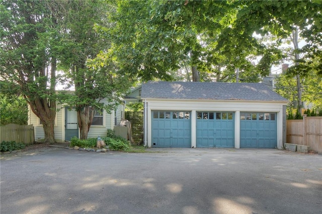 24 Old Beach Rd, Newport, RI 02840 - view of front of house featuring a chimney, an outdoor structure, and a detached garage